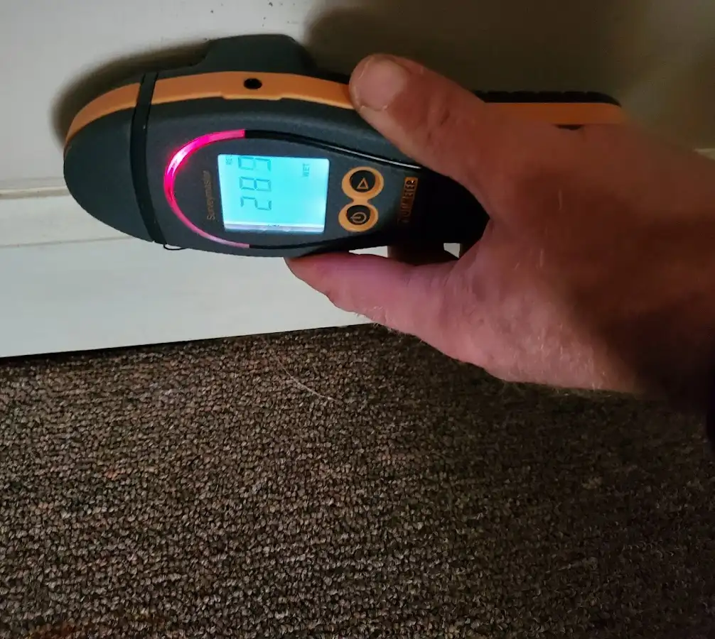 Moisture detection at baseboard during Storm Damage Restoration in Palm Beach
